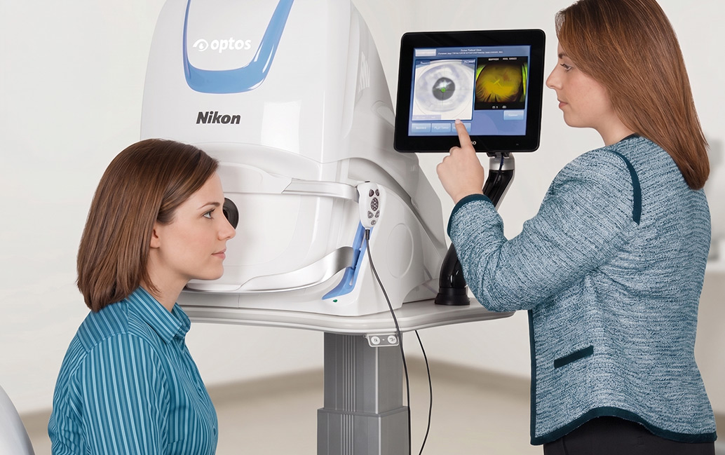Dr performing an Optos eye exam on a patient